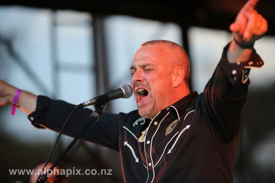 Rikki singing on stage